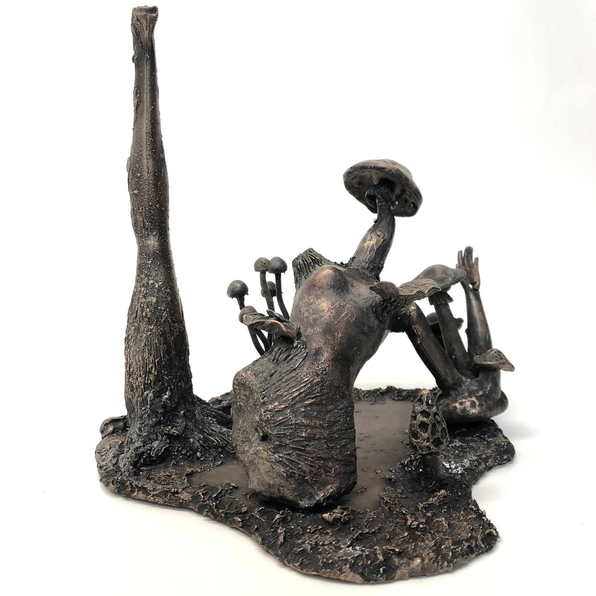 bronze sculpture of dismembered barbie doll with mushrooms